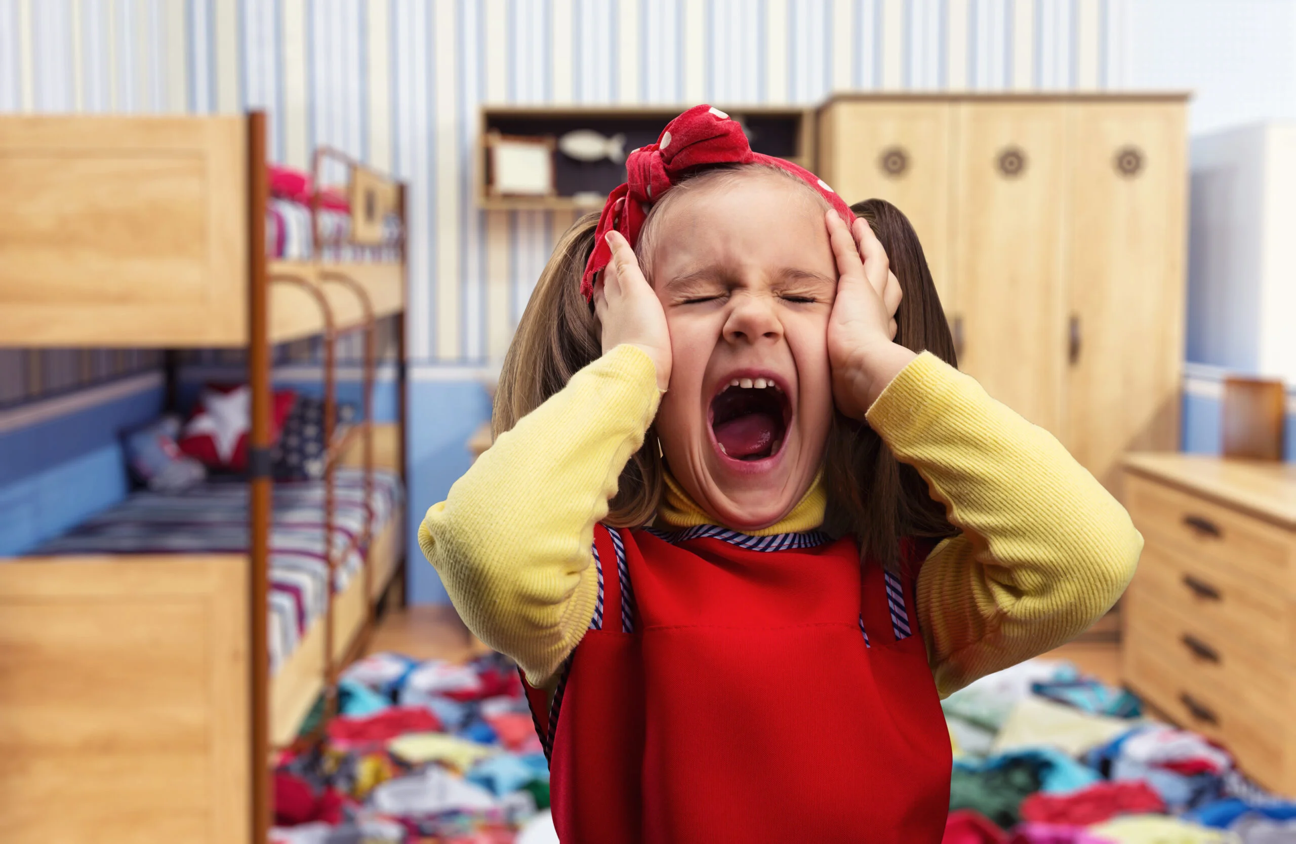 little-girl-screaming-home-with-her-ears-covered-by-hands-1