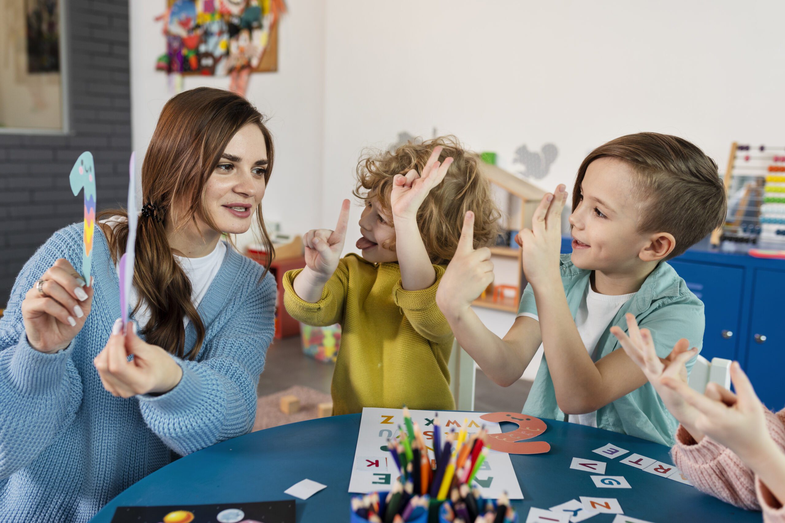 medium-shot-kids-teacher-table-1