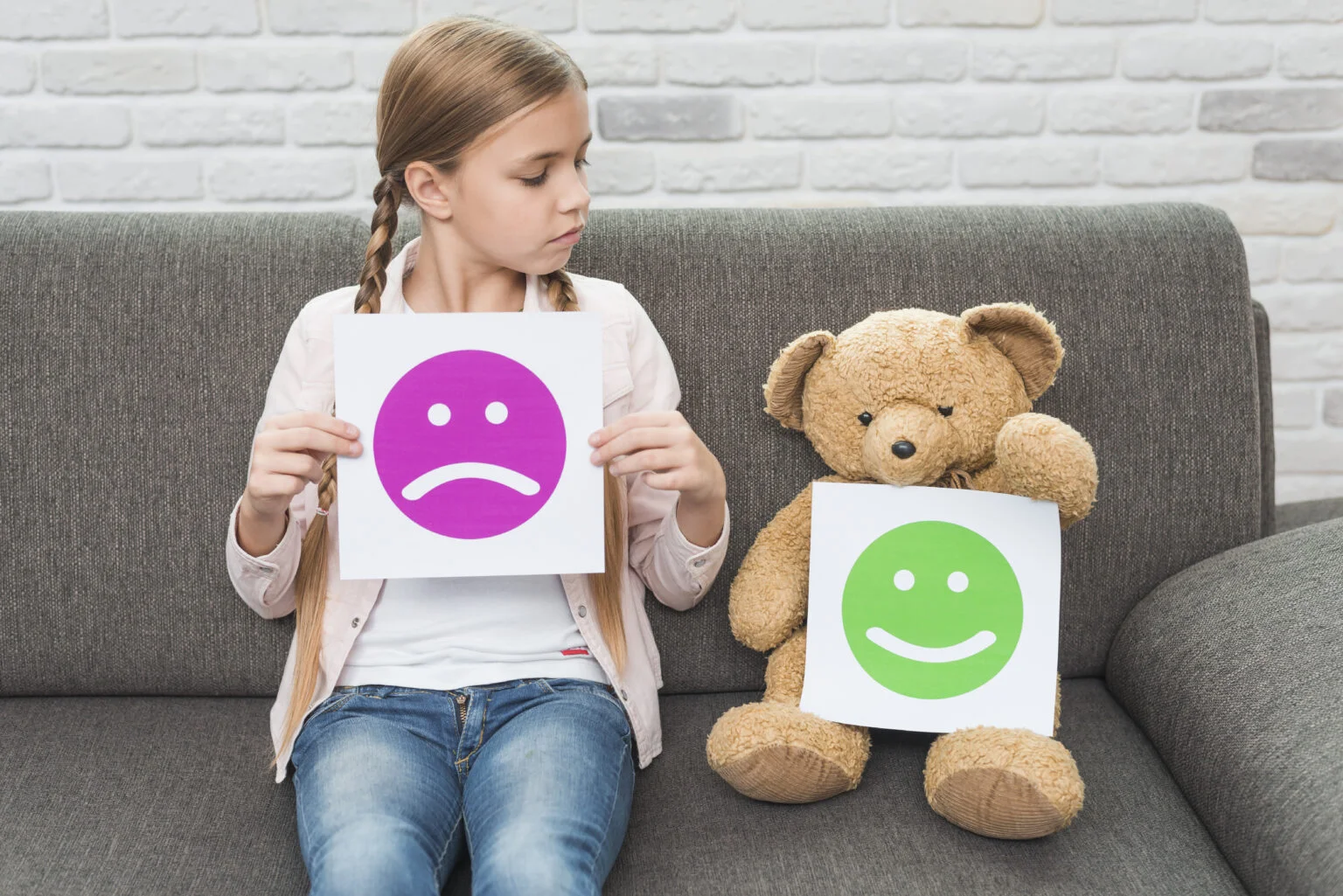 girl-holding-sad-smileys-paper-looking-teddy-bear-with-happy-smileys-1536x1025.jpg