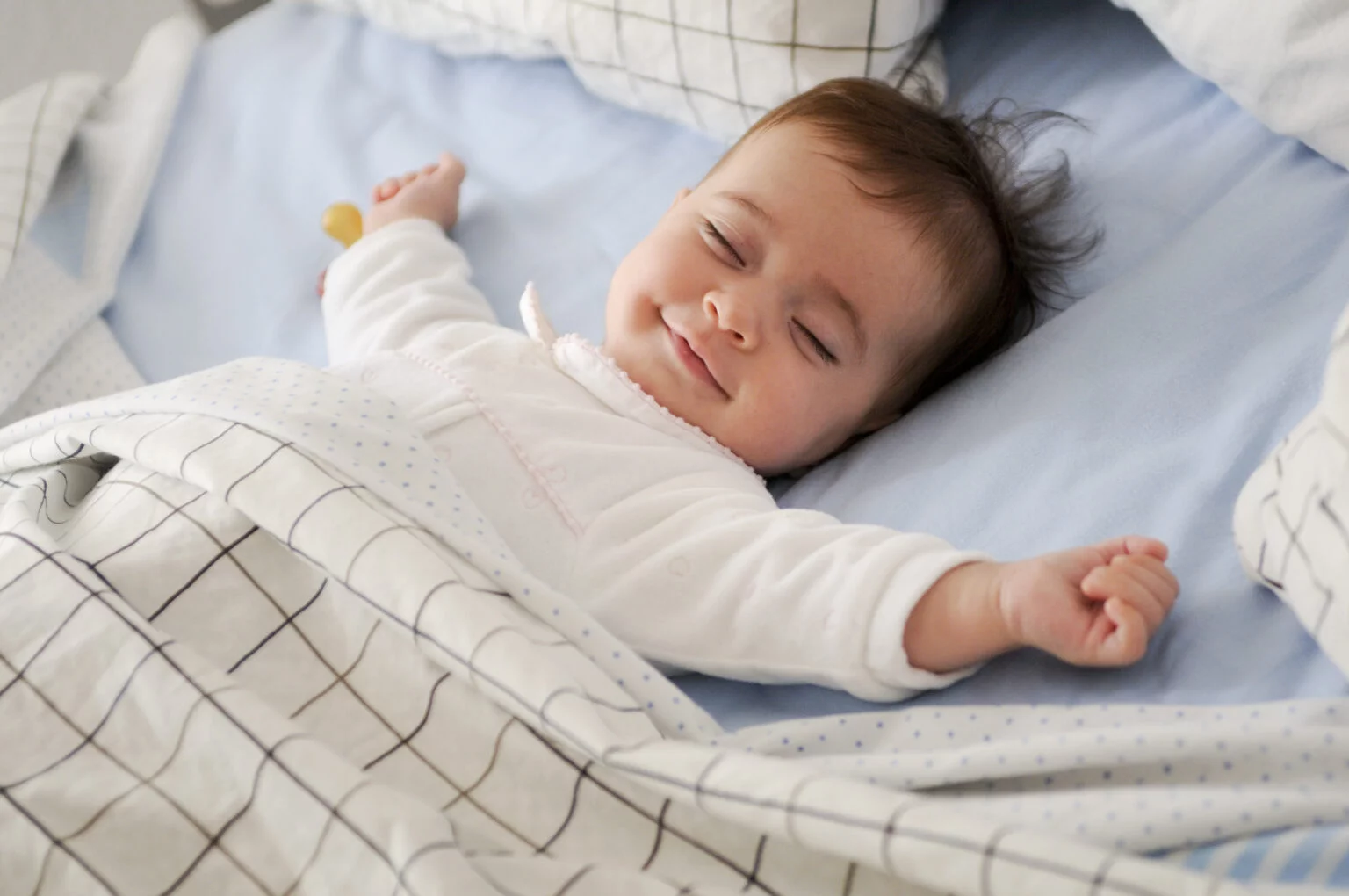 smiling-baby-lying-bed-1-1536x1020.jpg